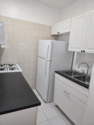 a kitchen with a sink and a refrigerator