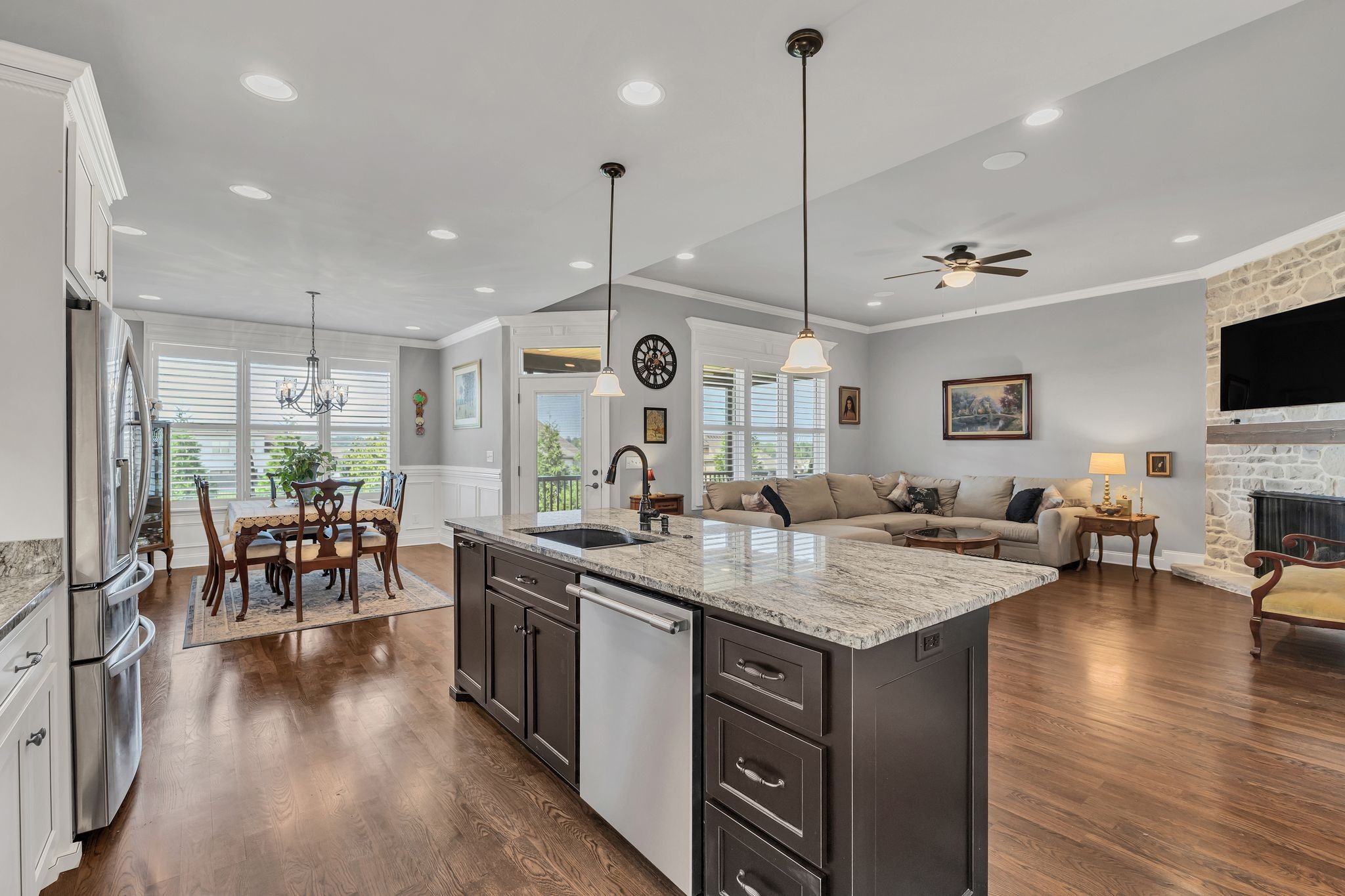 1007 Abbey Rd Way Spring Hill, TN 37174 - Photo 13 of 54 a kitchen with lots of counter space a sink appliances and living room view