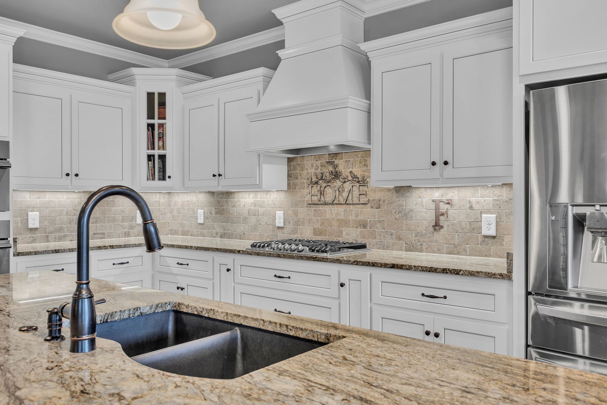 1007 Abbey Rd Way Spring Hill, TN 37174 - Photo 14 of 54 a kitchen with granite countertop a sink stainless steel appliances and cabinets