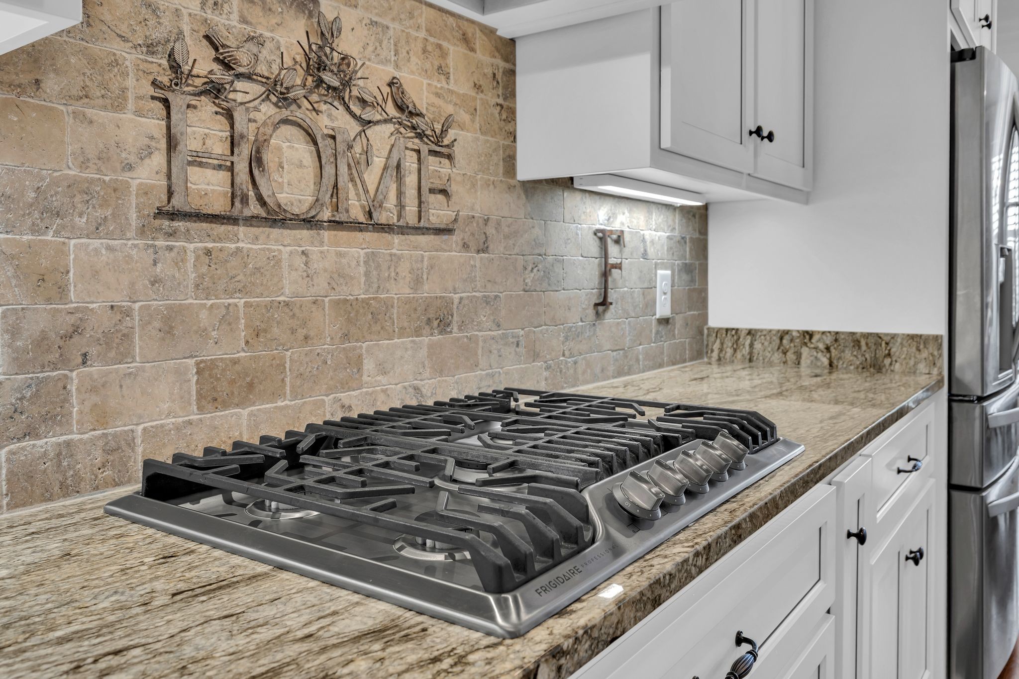 1007 Abbey Rd Way Spring Hill, TN 37174 - Photo 15 of 54 a kitchen with a stove a sink and cabinets