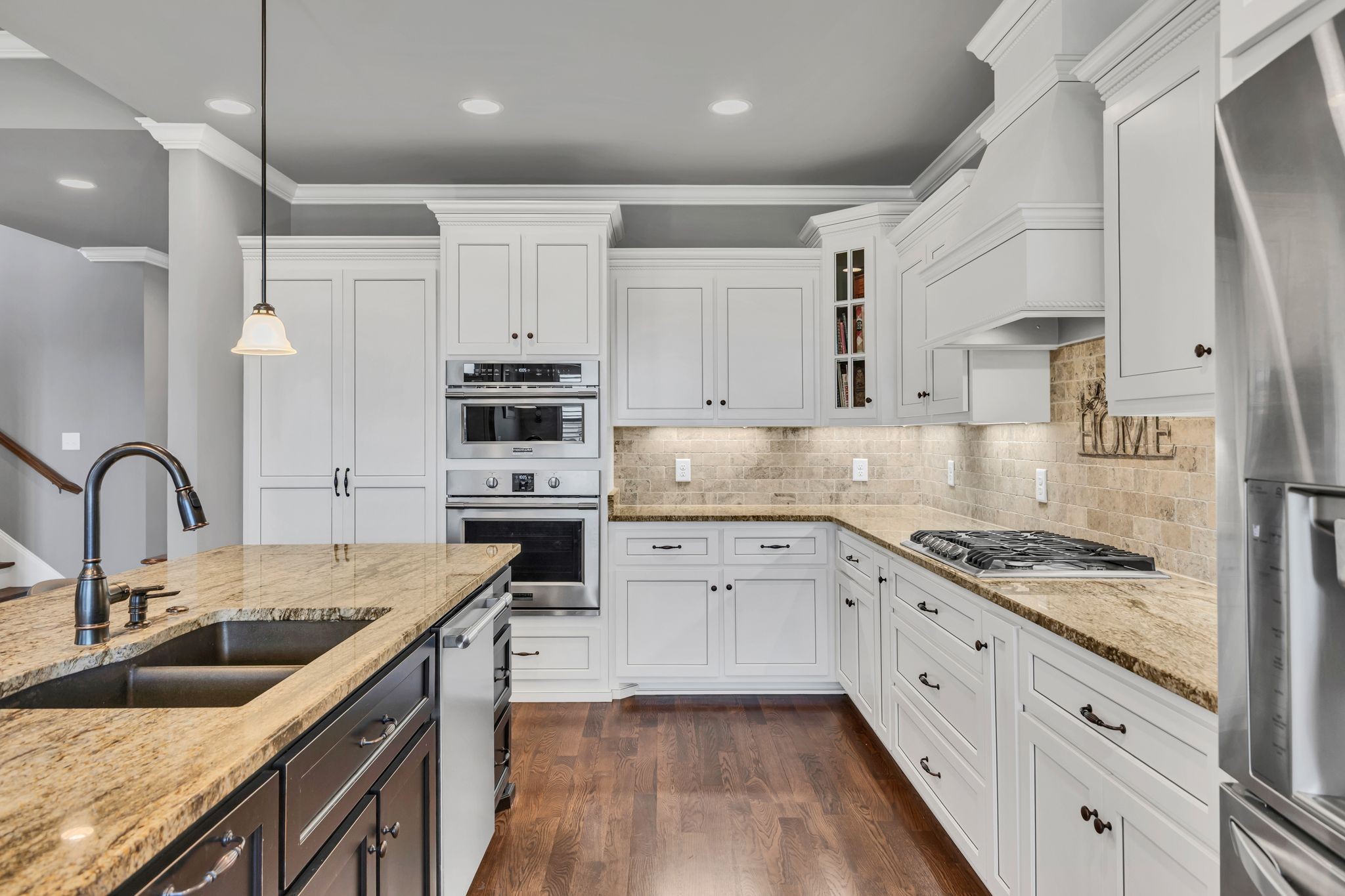 1007 Abbey Rd Way Spring Hill, TN 37174 - Photo 16 of 54 a kitchen with granite countertop a sink stainless steel appliances and cabinets