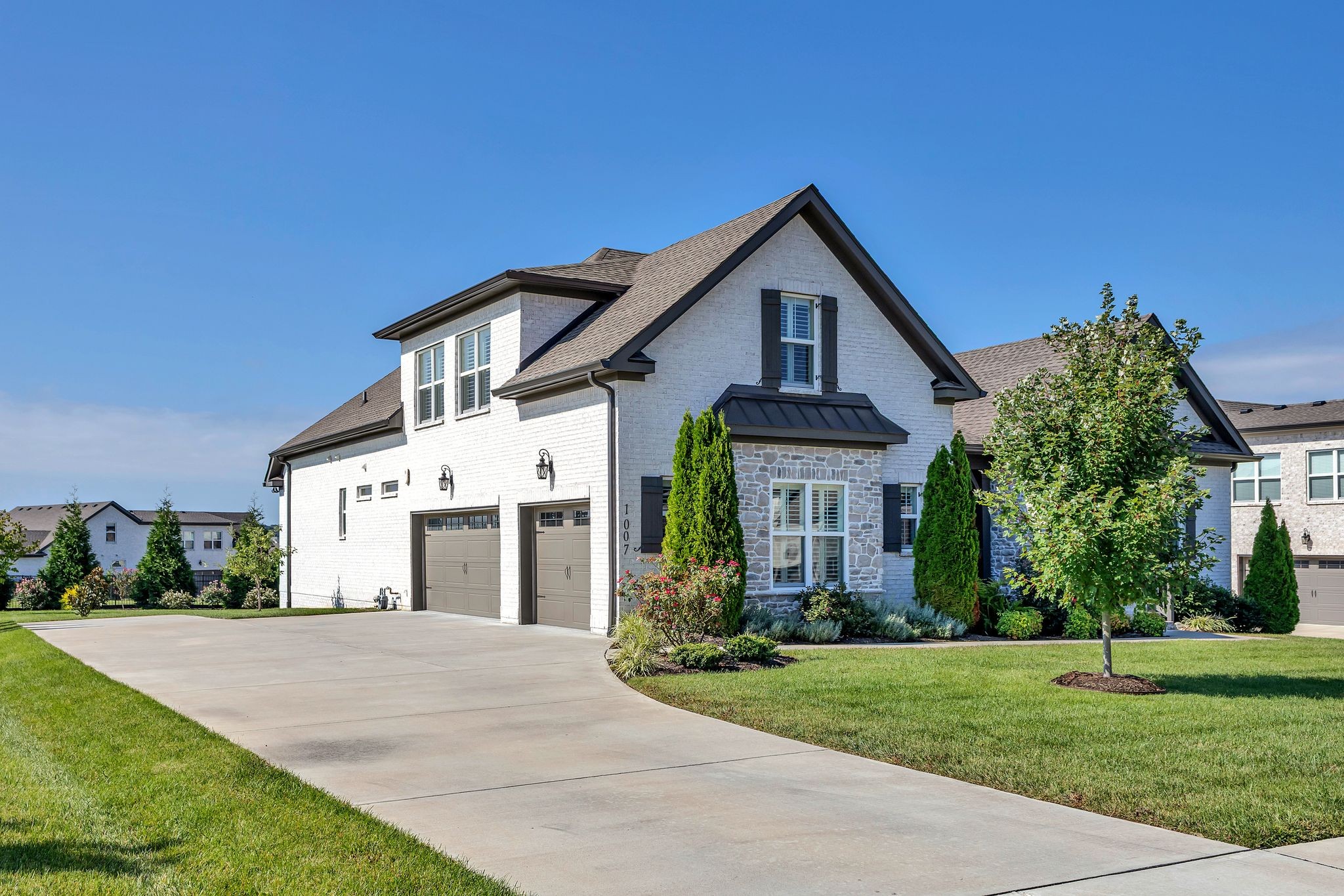 1007 Abbey Rd Way Spring Hill, TN 37174 - Photo 2 of 54 a front view of a house with a yard and garage