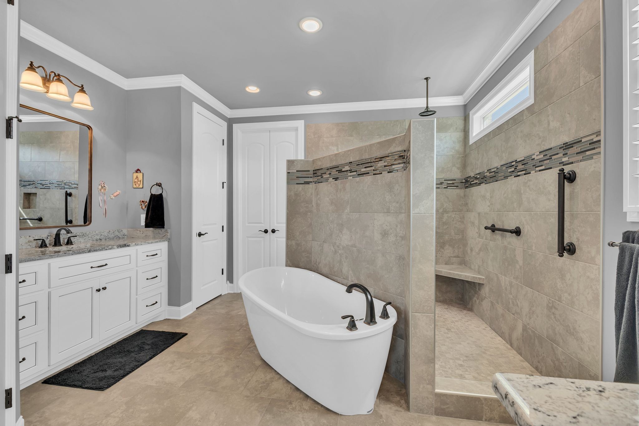 1007 Abbey Rd Way Spring Hill, TN 37174 - Photo 25 of 54 a bathroom with a granite countertop tub sink shower and mirror