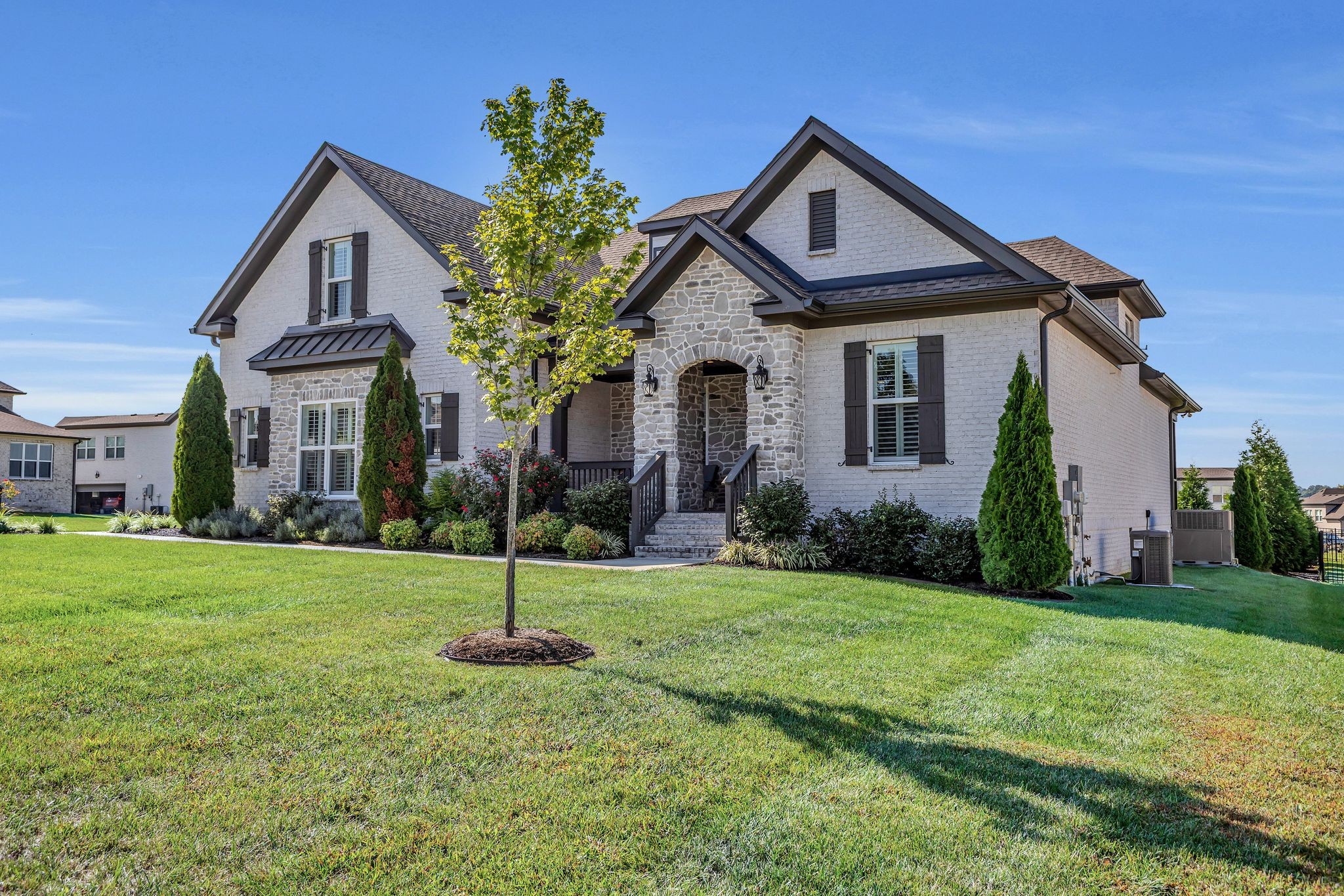 1007 Abbey Rd Way Spring Hill, TN 37174 - Photo 3 of 54 a front view of a house with a yard