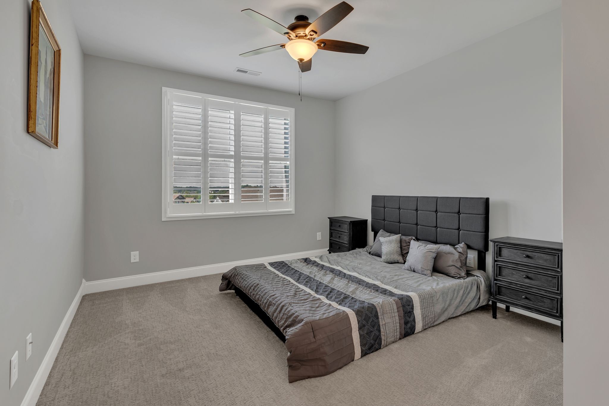 1007 Abbey Rd Way Spring Hill, TN 37174 - Photo 36 of 54 a bedroom with a bed and a chandelier