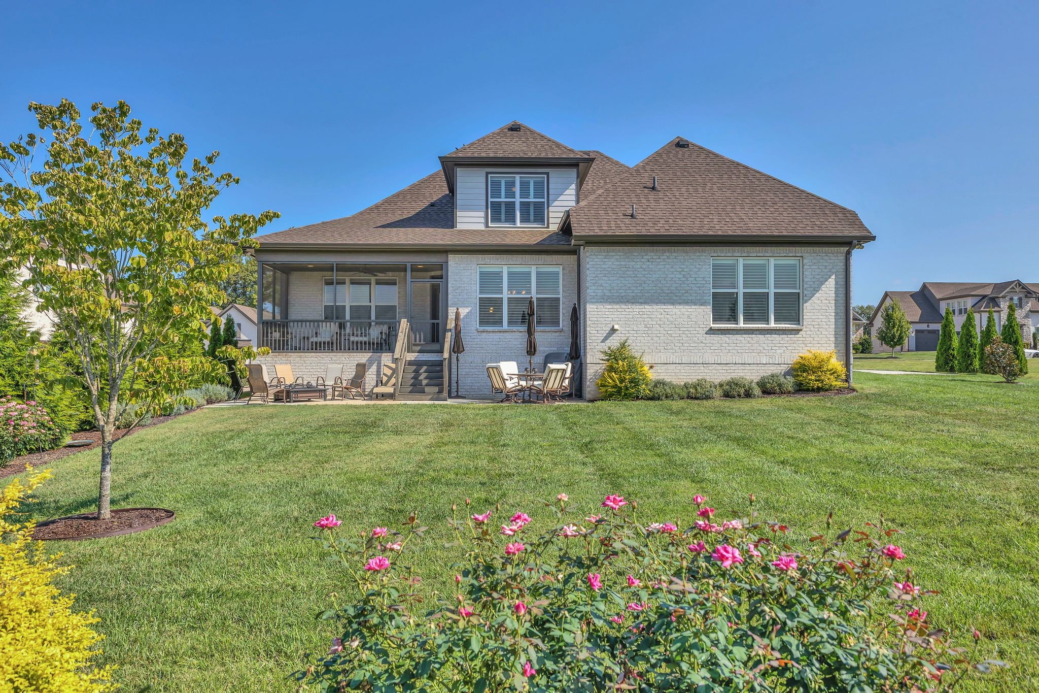 1007 Abbey Rd Way Spring Hill, TN 37174 - Photo 50 of 54 a front view of a house with a big yard and potted plants