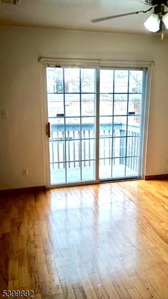 809 South 17th Street, Unit 2 Newark, NJ 07108 - Photo 2 of 5 a view of an empty room with a window and wooden floor