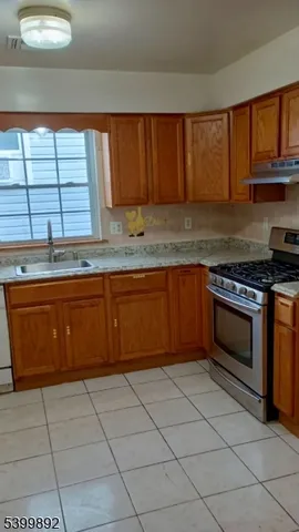 a kitchen with stainless steel appliances granite countertop a stove sink and cabinets