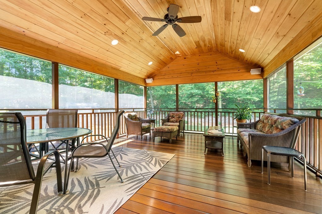243 Hill Road Groton, MA 01450 - Photo 11 of 30 a view of a patio with dining table and chairs