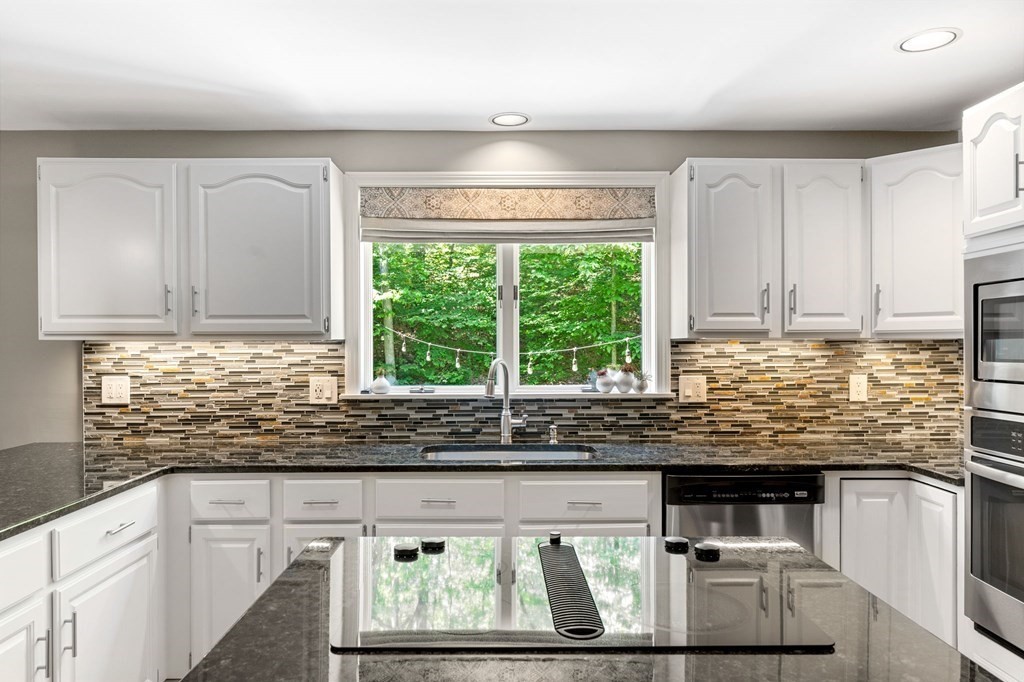 243 Hill Road Groton, MA 01450 - Photo 3 of 30 a kitchen with stainless steel appliances kitchen island granite countertop a sink and a white cabinets
