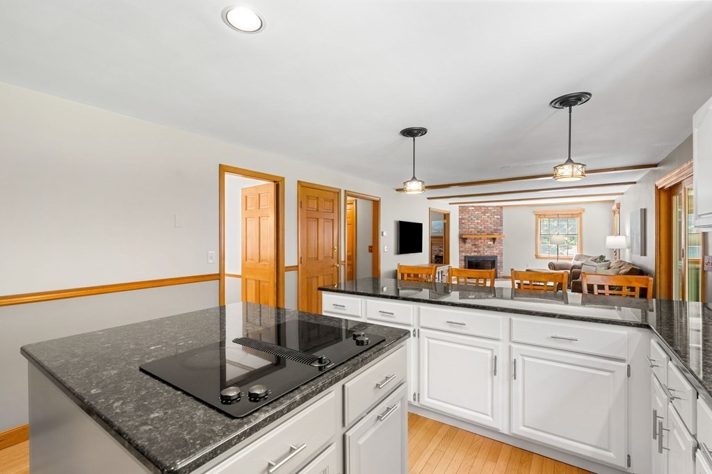 243 Hill Road Groton, MA 01450 - Photo 5 of 30 a kitchen with stainless steel appliances granite countertop a sink and a wooden cabinets