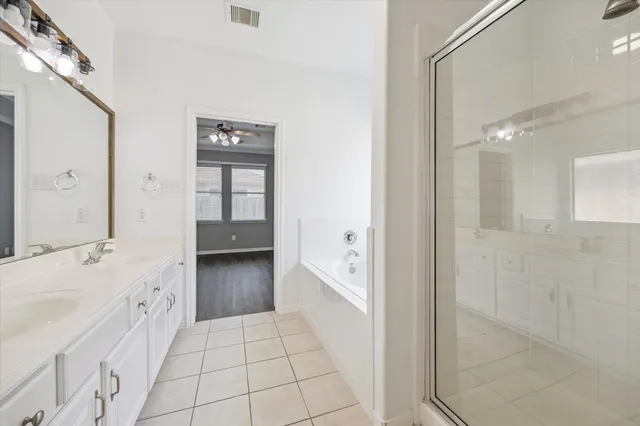 a bathroom with a granite countertop sink a toilet and bathtub