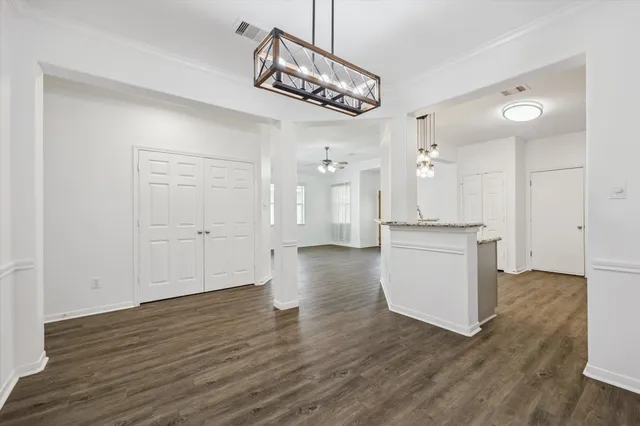 a view of a kitchen with wooden floor and a sink