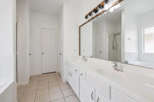 a spacious bathroom with a double vanity sink mirror and