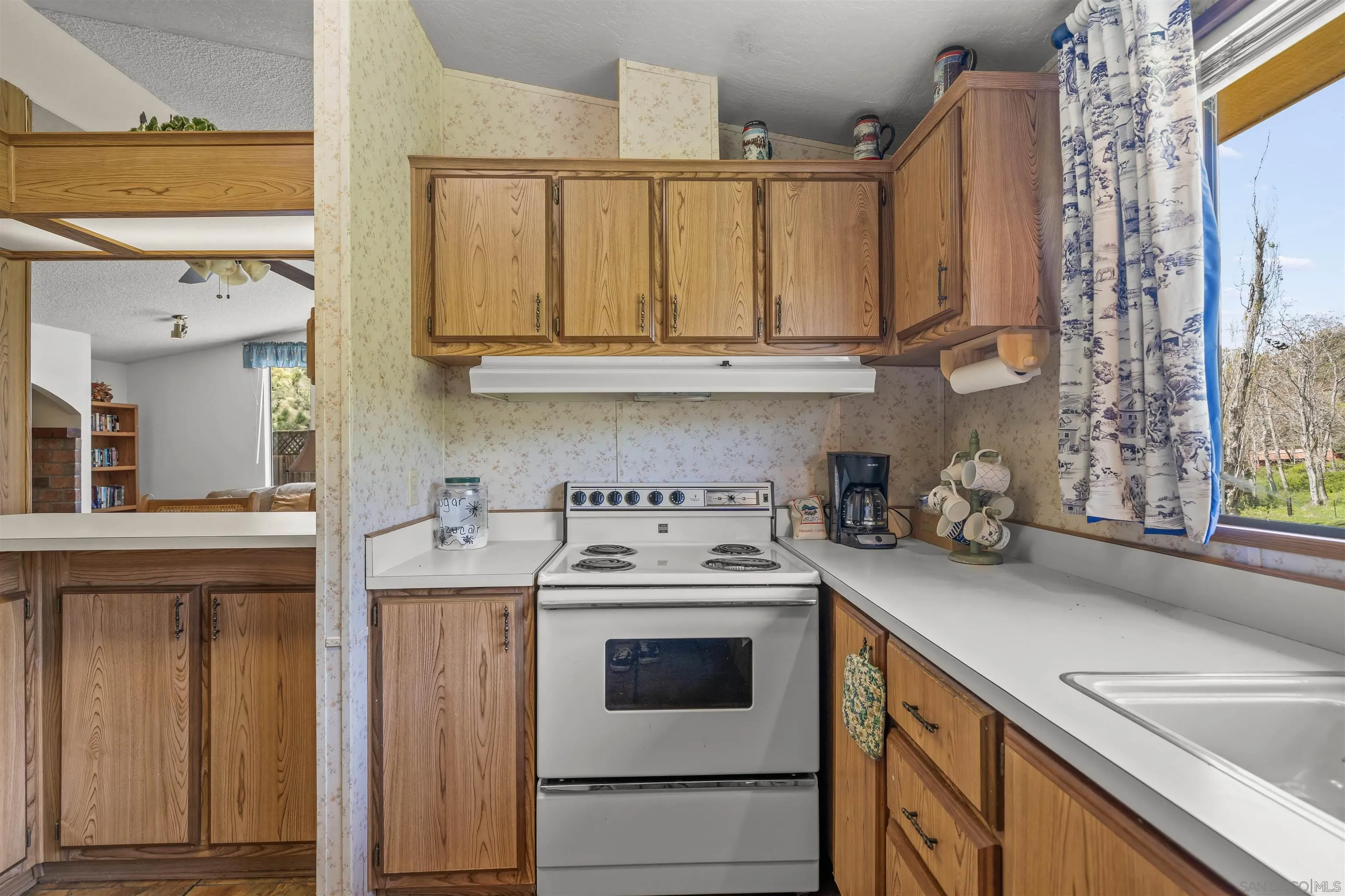 2464 Wynola Road Julian, CA 92036 - Photo 24 of 50 a kitchen with granite countertop a sink a stove and cabinets