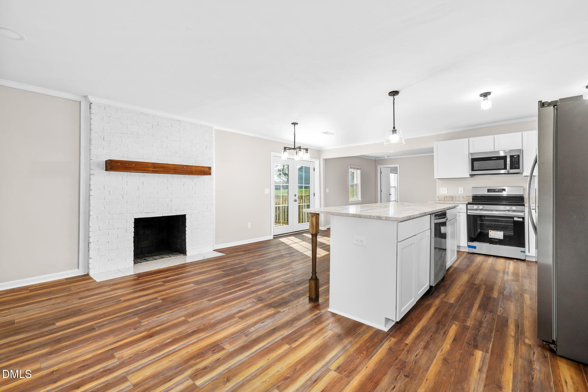 426 Rooker Dairy Road Norlina, NC 27563 - Photo 6 of 33 a large kitchen with cabinets wooden floor and stainless steel appliances