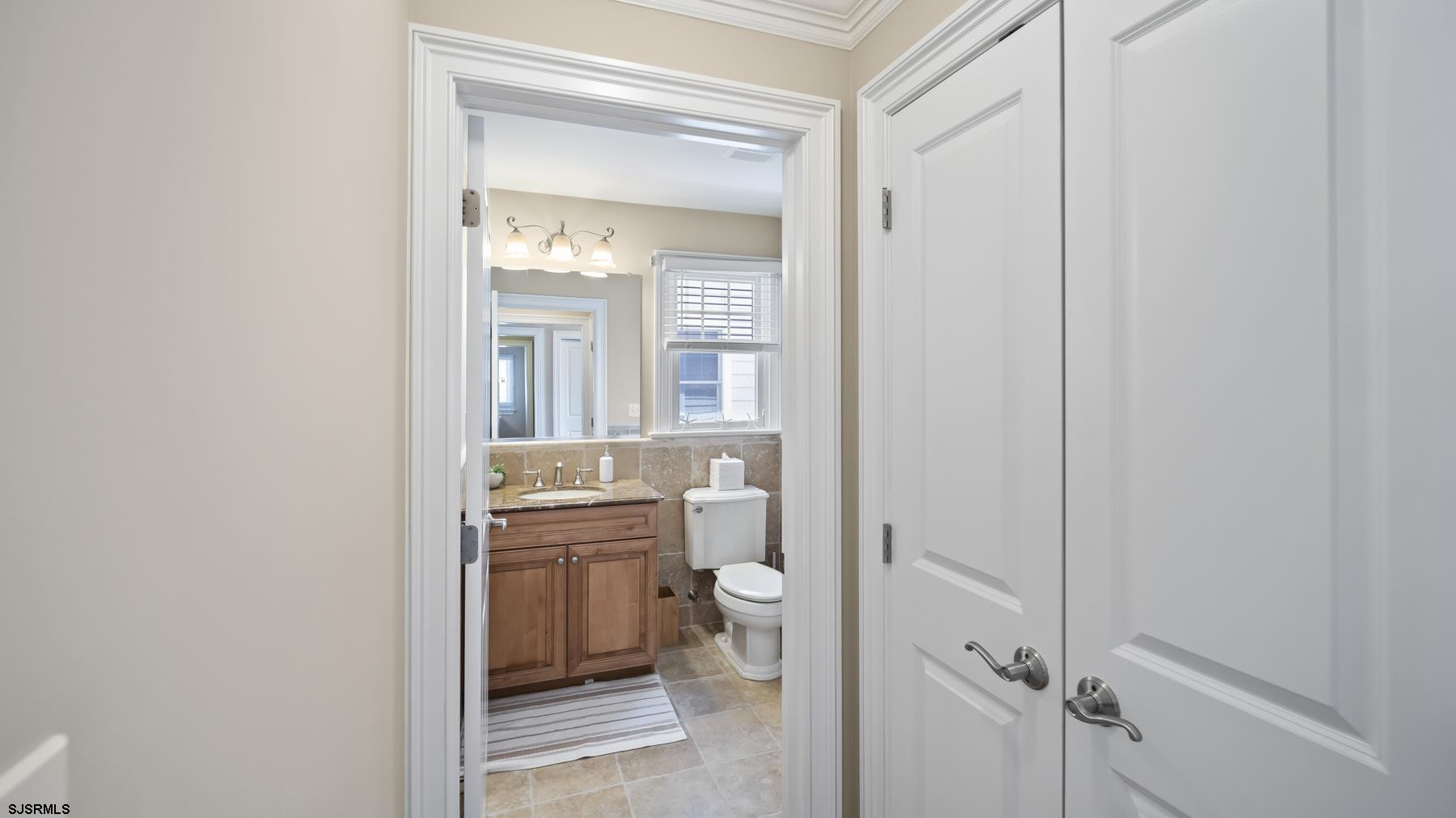 23 Walnut Road Ocean City, NJ 08226 - Photo 16 of 47 a bathroom with a granite countertop toilet a sink and mirror