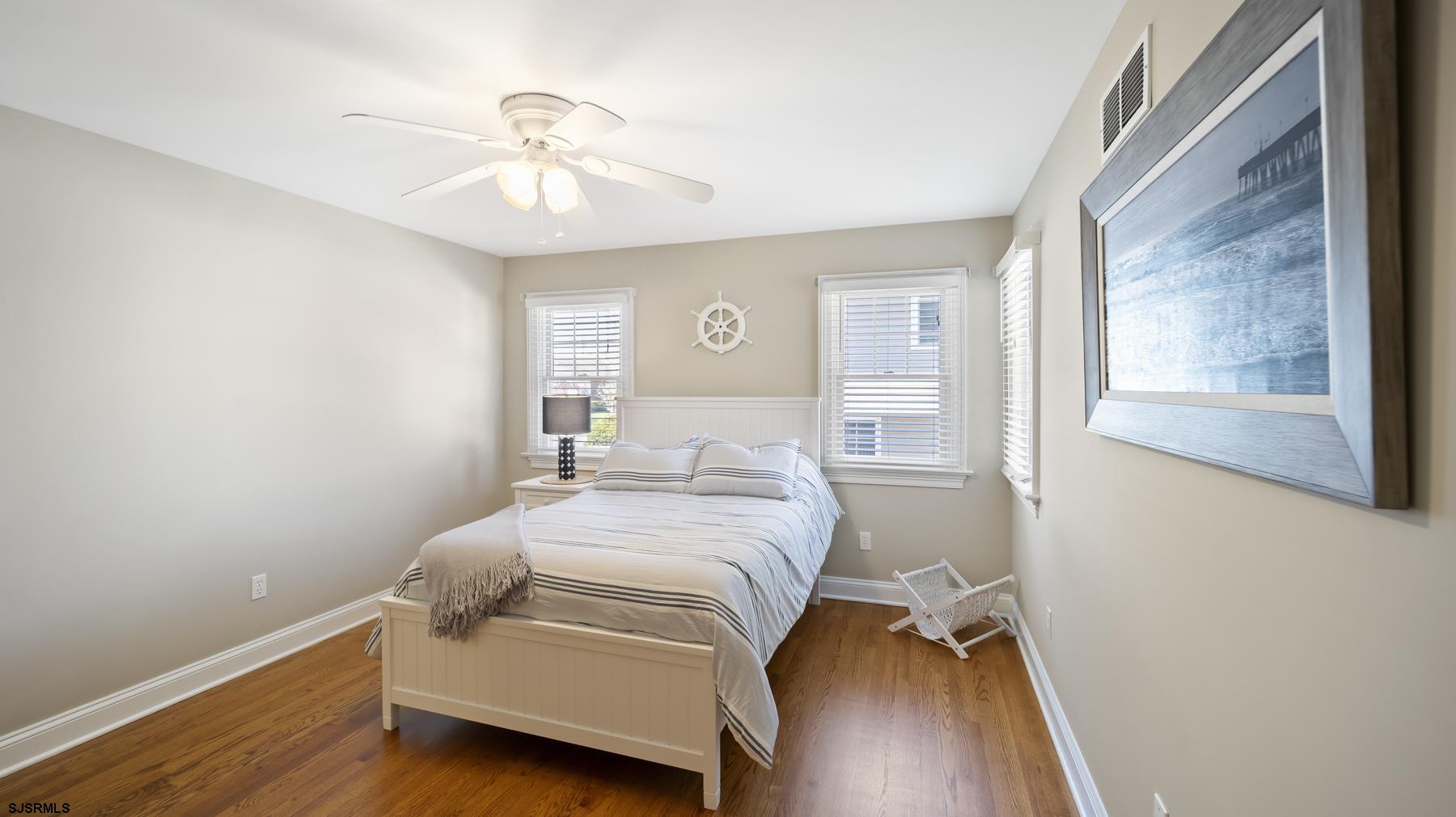 23 Walnut Road Ocean City, NJ 08226 - Photo 17 of 47 a room with a bed and a chandelier