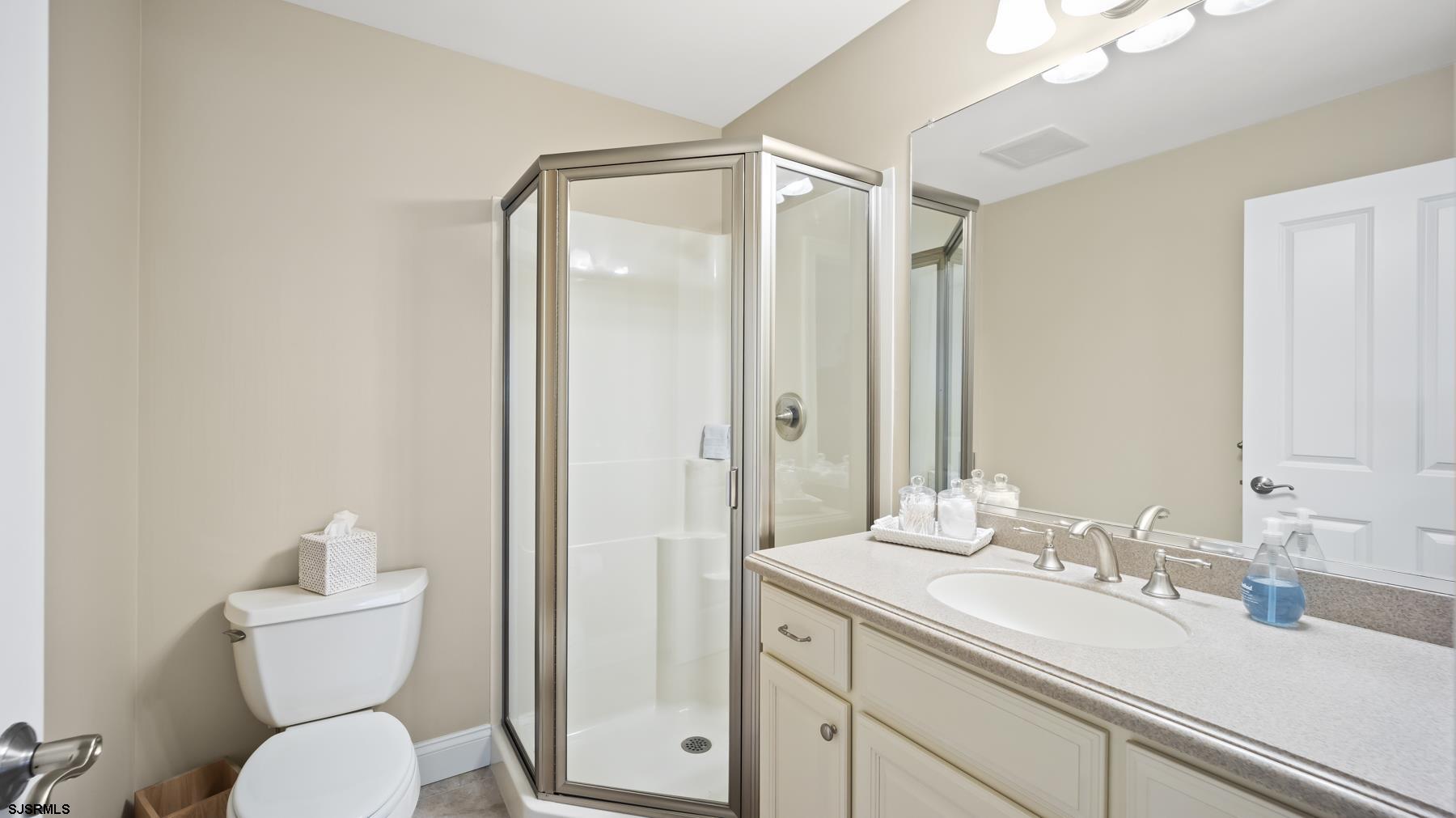 23 Walnut Road Ocean City, NJ 08226 - Photo 18 of 47 a bathroom with a toilet shower vanity and a sink