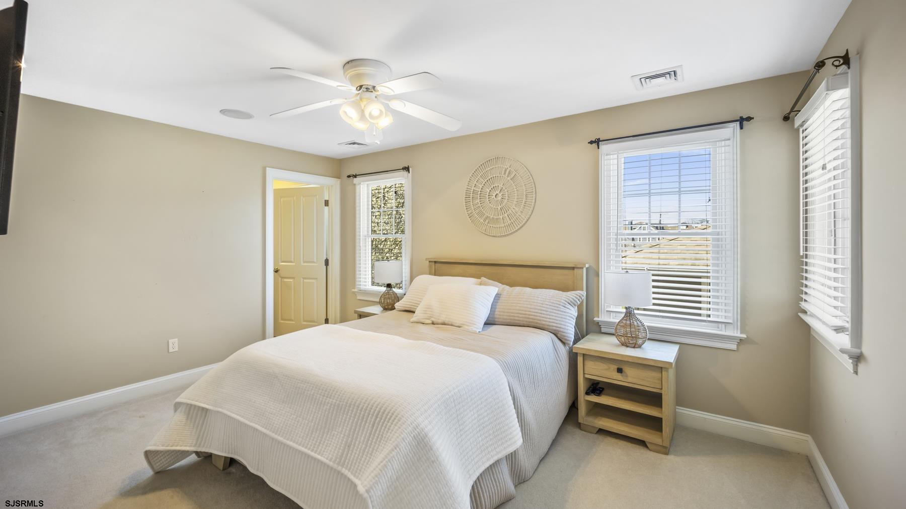 23 Walnut Road Ocean City, NJ 08226 - Photo 27 of 47 a bedroom with a bed and a chandelier