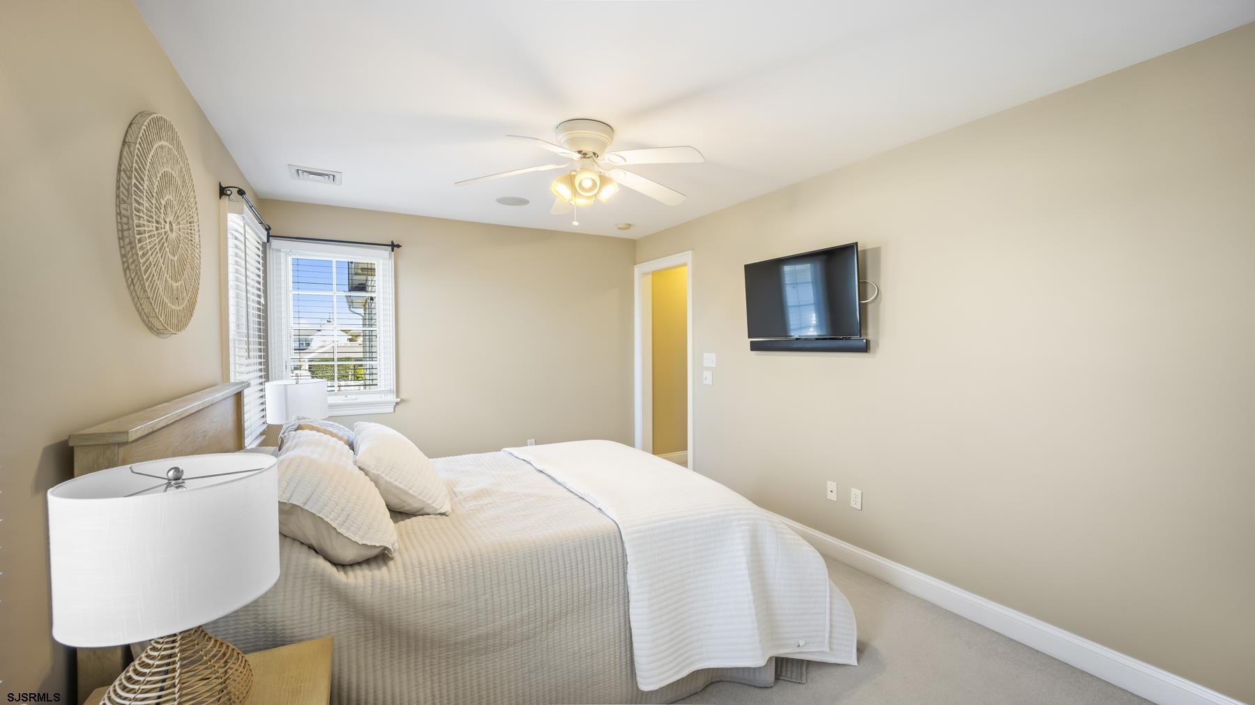 23 Walnut Road Ocean City, NJ 08226 - Photo 29 of 47 a bedroom with a bed and a chandelier