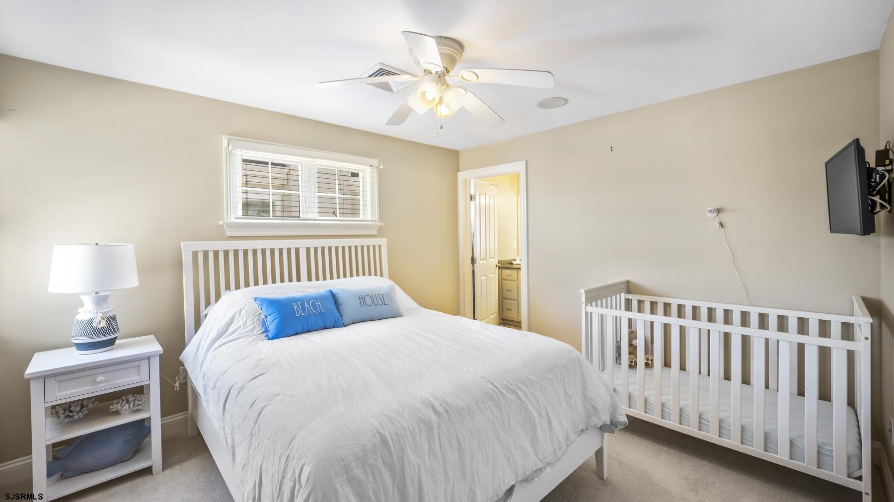 23 Walnut Road Ocean City, NJ 08226 - Photo 30 of 47 a bedroom with a bed and a tv