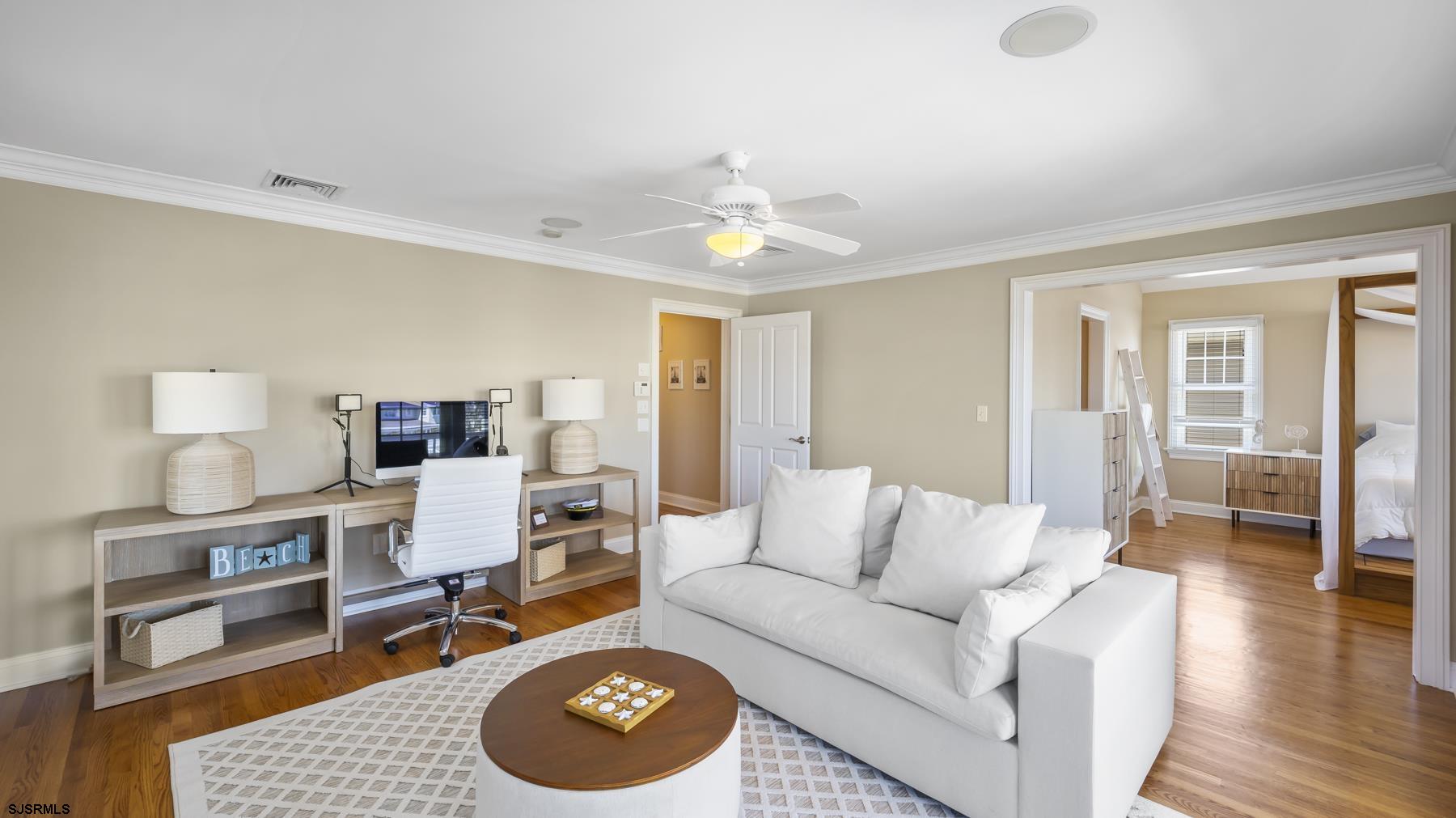 23 Walnut Road Ocean City, NJ 08226 - Photo 35 of 47 a living room with furniture a rug and a chandelier