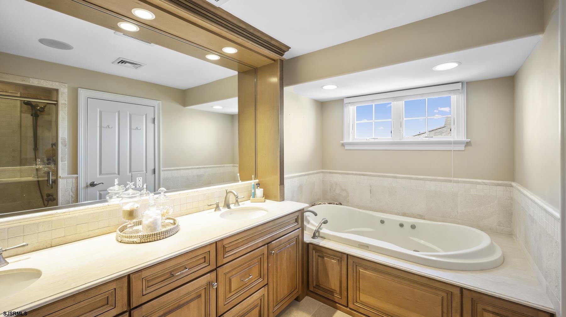 23 Walnut Road Ocean City, NJ 08226 - Photo 40 of 47 a bathroom with a granite countertop sink and a bathtub