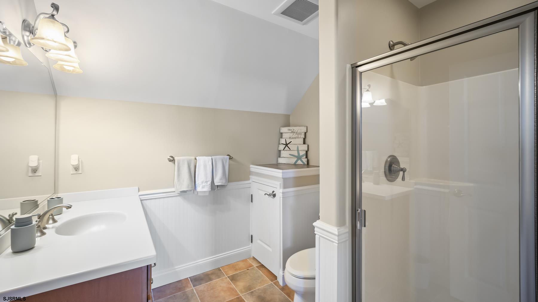 23 Walnut Road Ocean City, NJ 08226 - Photo 45 of 47 a bathroom with a sink a toilet and shower