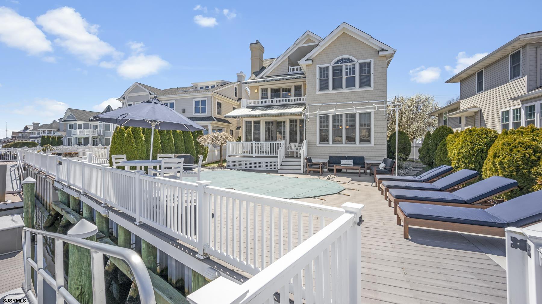 23 Walnut Road Ocean City, NJ 08226 - Photo 46 of 47 a view of a house with wooden deck and furniture