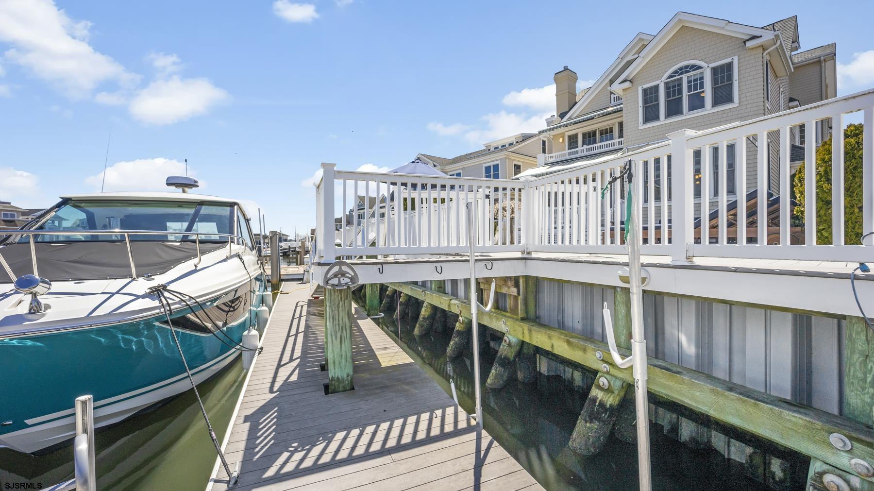 23 Walnut Road Ocean City, NJ 08226 - Photo 10 of 47 a balcony with wooden floor and outdoor seating