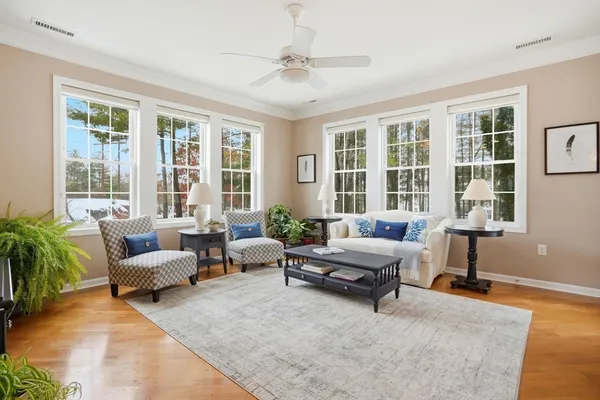 a living room with furniture and floor to ceiling windows