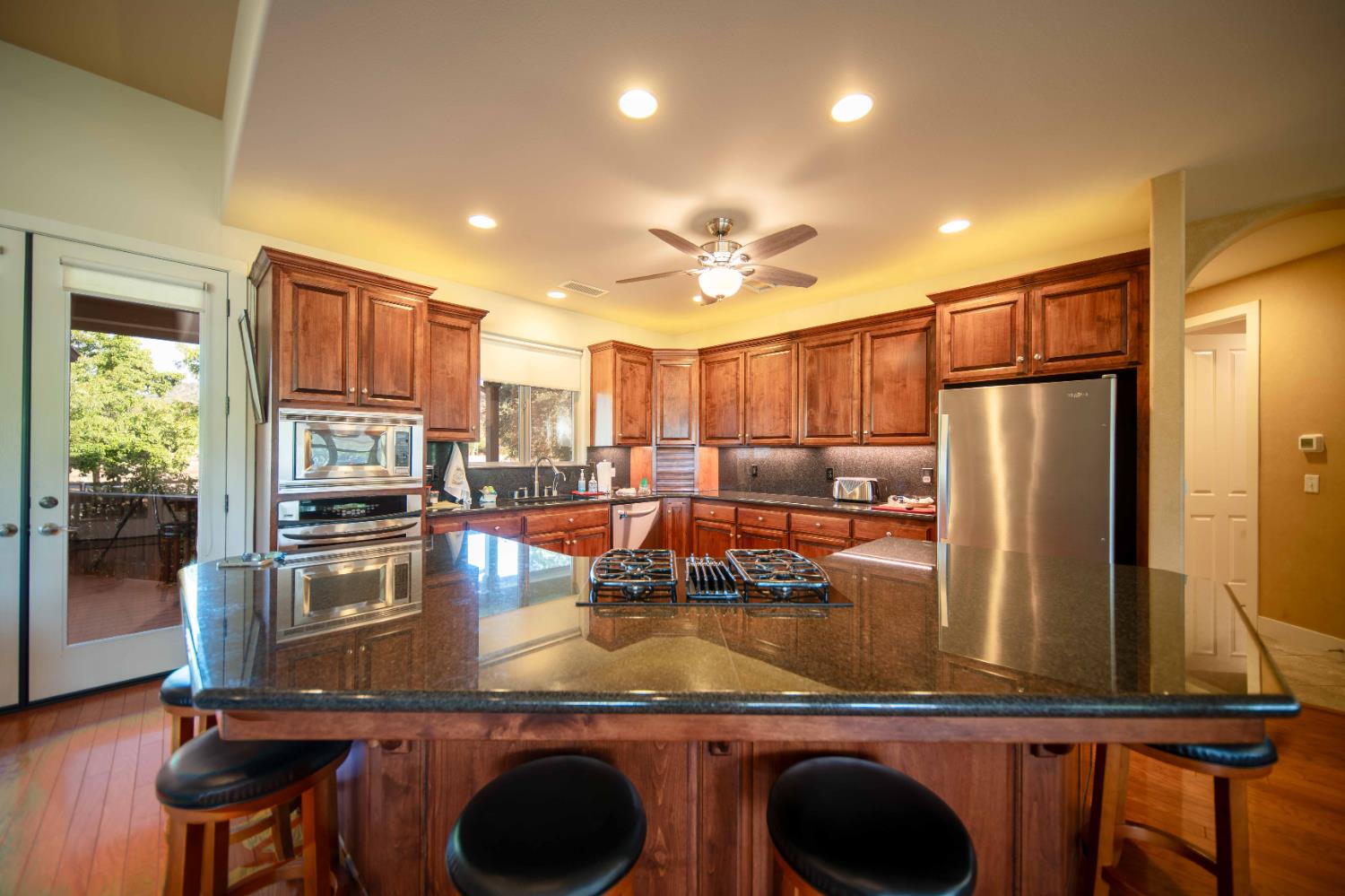 26027 Auberry Road Clovis, CA 93619 - Photo 17 of 46 a kitchen with kitchen island a counter top space cabinets and stainless steel appliances
