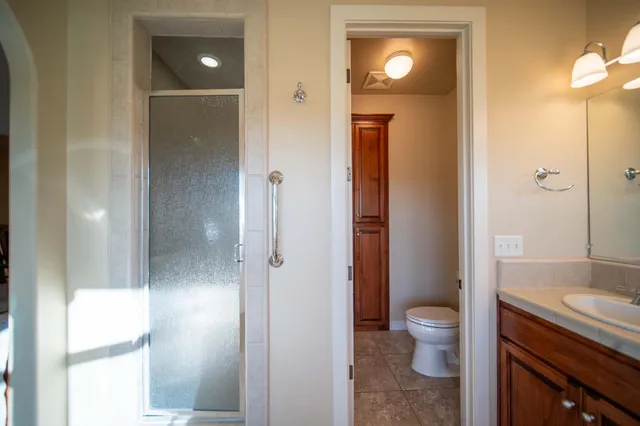 a bathroom with a sink a toilet and a mirror