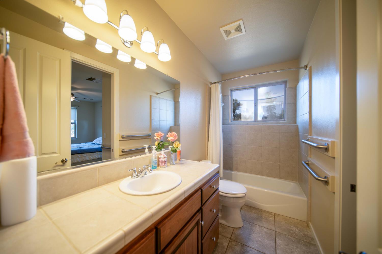 26027 Auberry Road Clovis, CA 93619 - Photo 28 of 46 a bathroom with a sink a toilet and a mirror