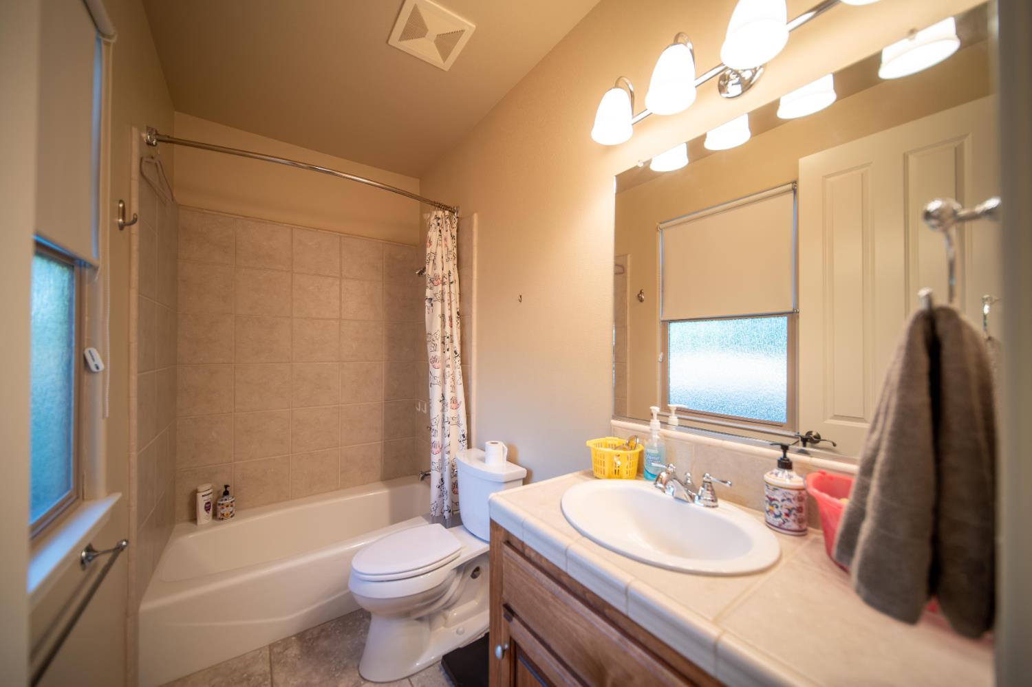 26027 Auberry Road Clovis, CA 93619 - Photo 33 of 46 a bathroom with a sink a toilet and shower