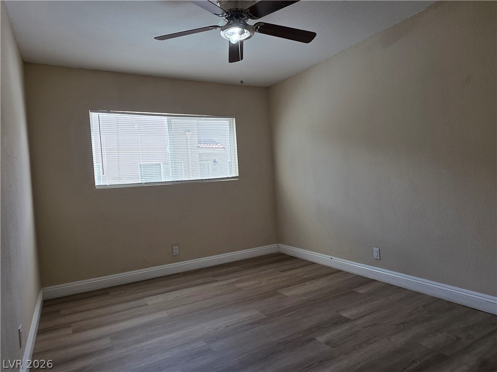 1844 North Decatur Boulevard, Unit 204 Las Vegas, NV 89108 - Photo 11 of 21 A windowed bedroom contains wood-look flooring and clean baseboard trim.