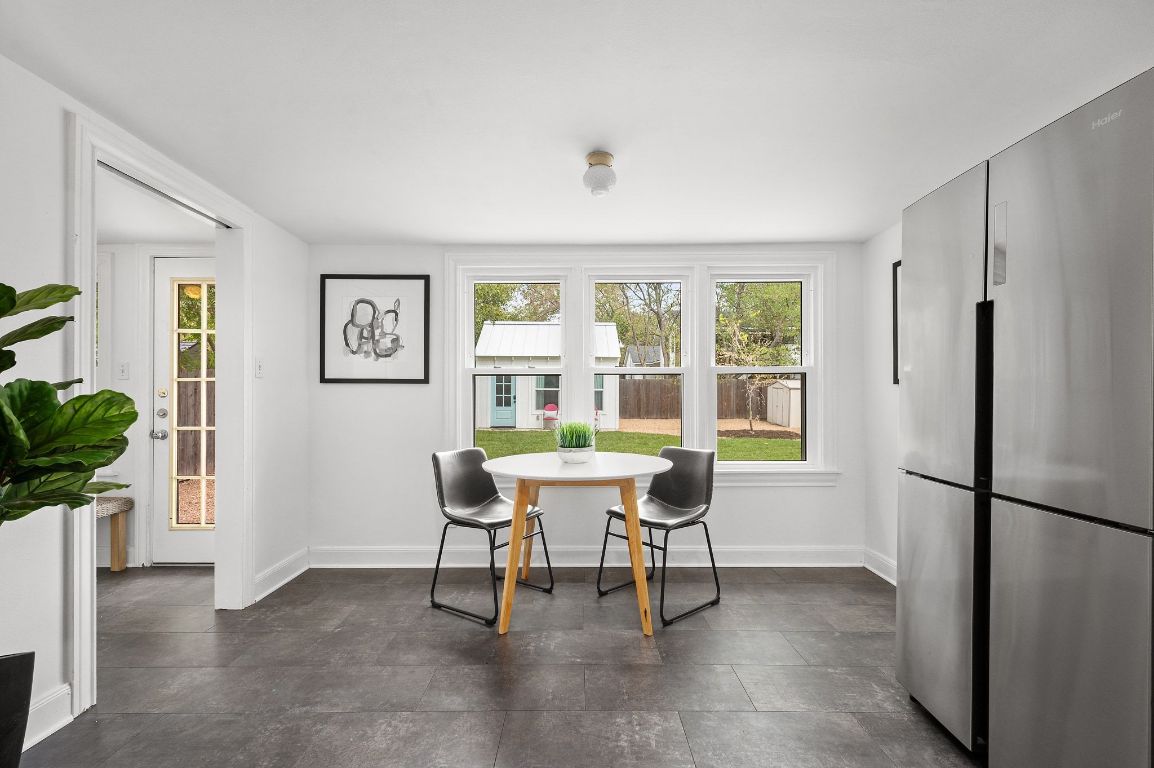 1412 Palo Duro Road Austin, TX 78757 - Photo 12 of 32 a work room with furniture a large window and a refrigerator