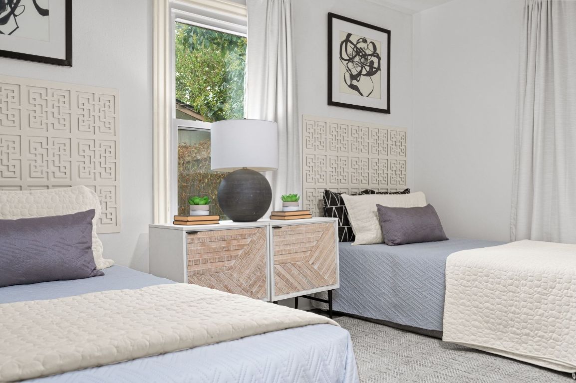 1412 Palo Duro Road Austin, TX 78757 - Photo 18 of 32 a bedroom with a bed and a painting on the wall