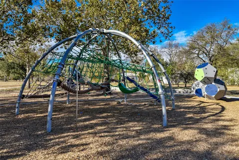 a view of park with swings and slides