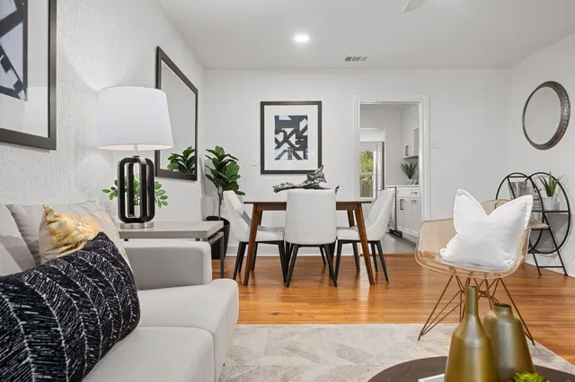 a dining room with furniture and wooden floor