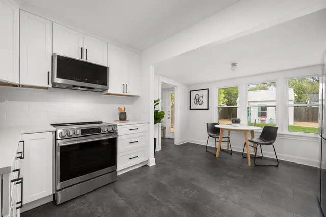 a kitchen with stainless steel appliances a stove a sink and a microwave