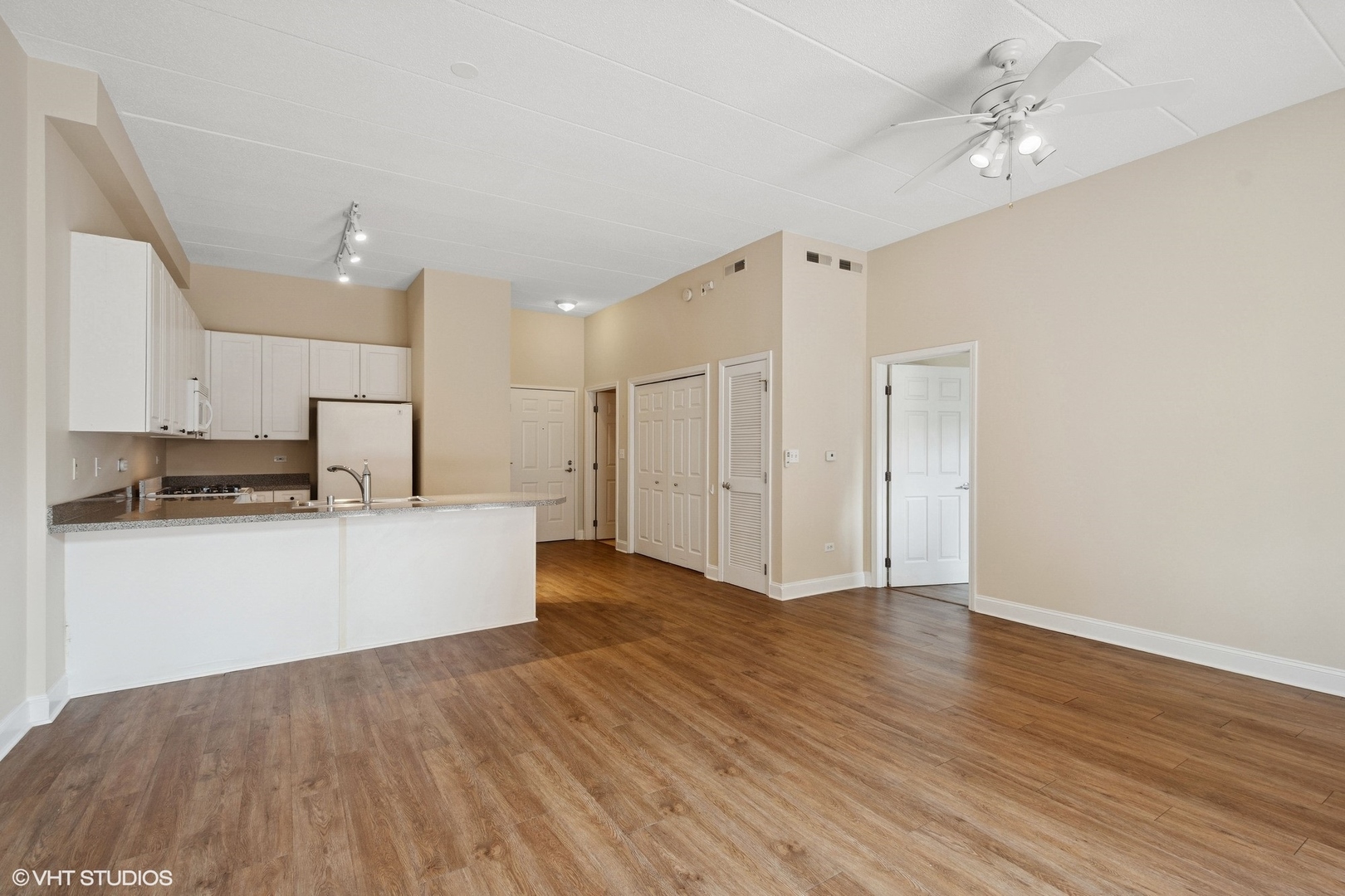 1301 West Washington Boulevard, Unit 203 Chicago, IL 60607 - Photo 5 of 15 a view of kitchen with stainless steel appliances refrigerator stove and wooden floor