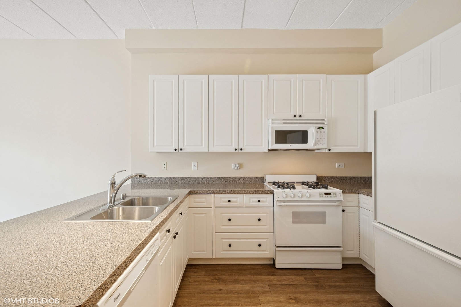 1301 West Washington Boulevard, Unit 203 Chicago, IL 60607 - Photo 6 of 15 a kitchen with white cabinets sink and stainless steel appliances