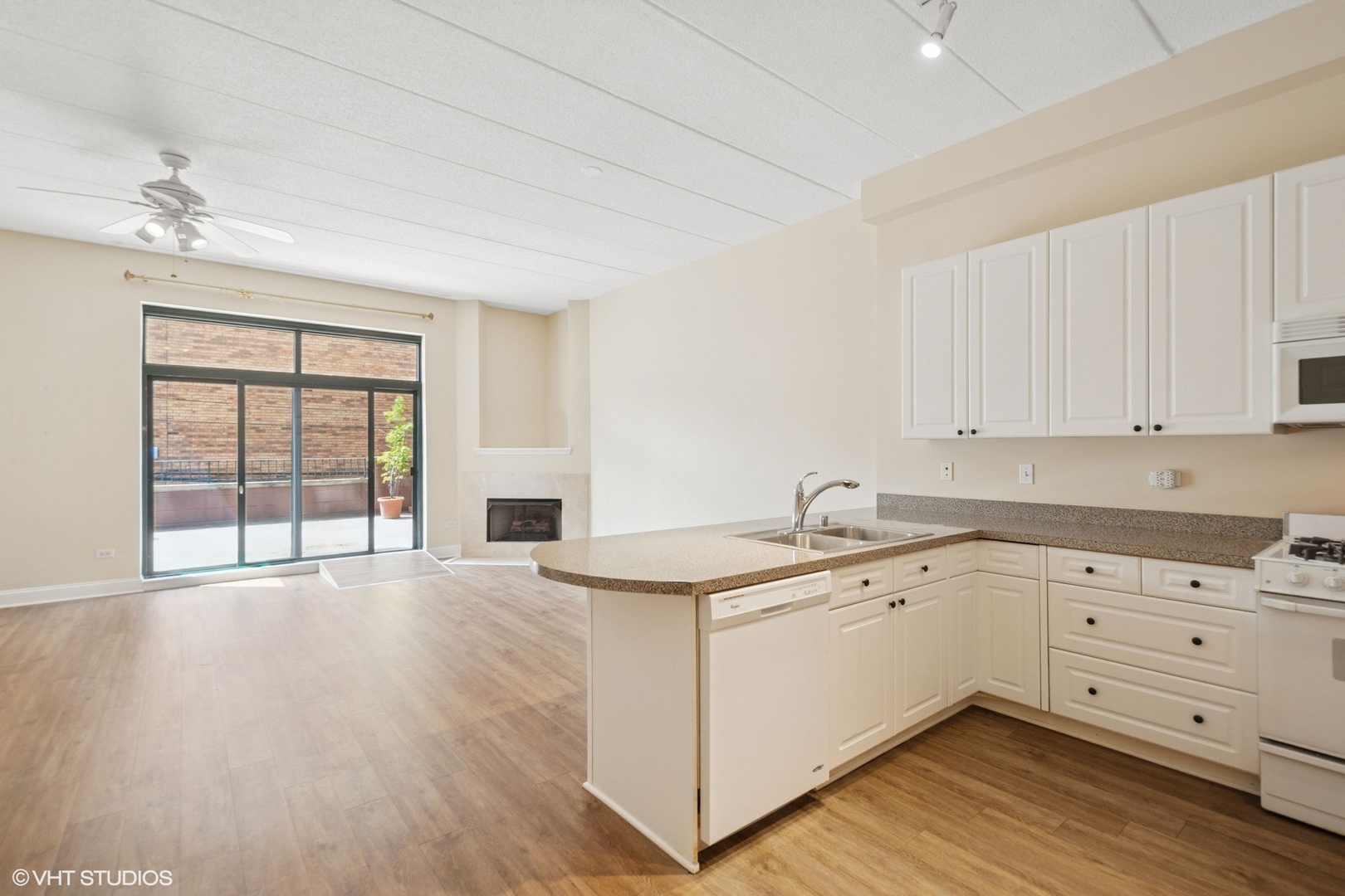 1301 West Washington Boulevard, Unit 203 Chicago, IL 60607 - Photo 7 of 15 a view of a kitchen sink and dishwasher with wooden floor