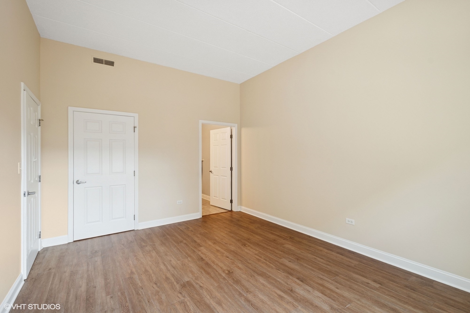 1301 West Washington Boulevard, Unit 203 Chicago, IL 60607 - Photo 9 of 15 a view of an empty room with wooden floor
