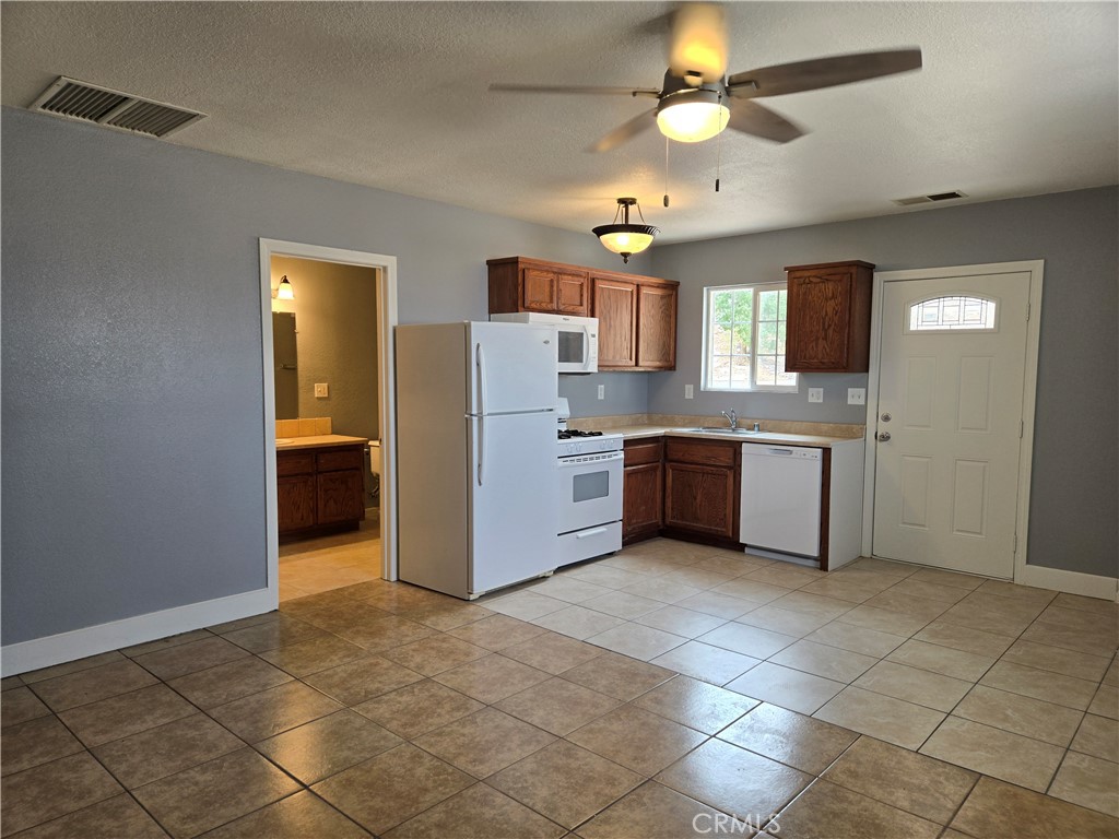 6467 Oak Hill Road, Unit B Oak Hills, CA 92344 - Photo 4 of 12 a kitchen with cabinets and stainless steel appliances