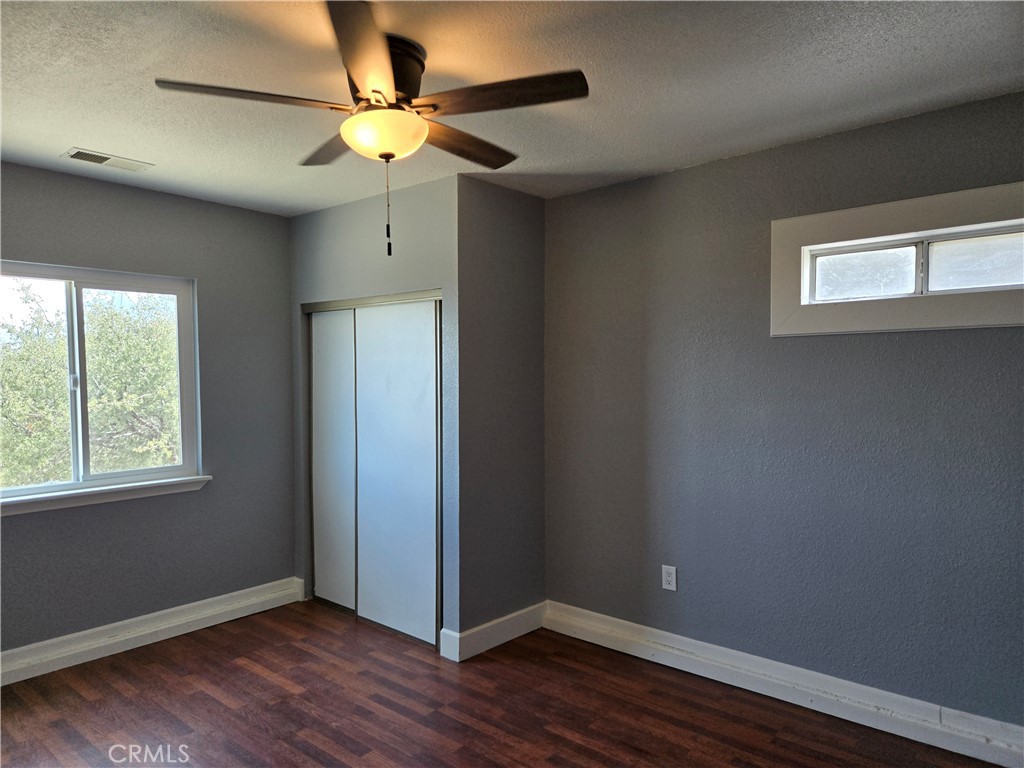 6467 Oak Hill Road, Unit B Oak Hills, CA 92344 - Photo 9 of 12 a view of an empty room with window and wooden floor