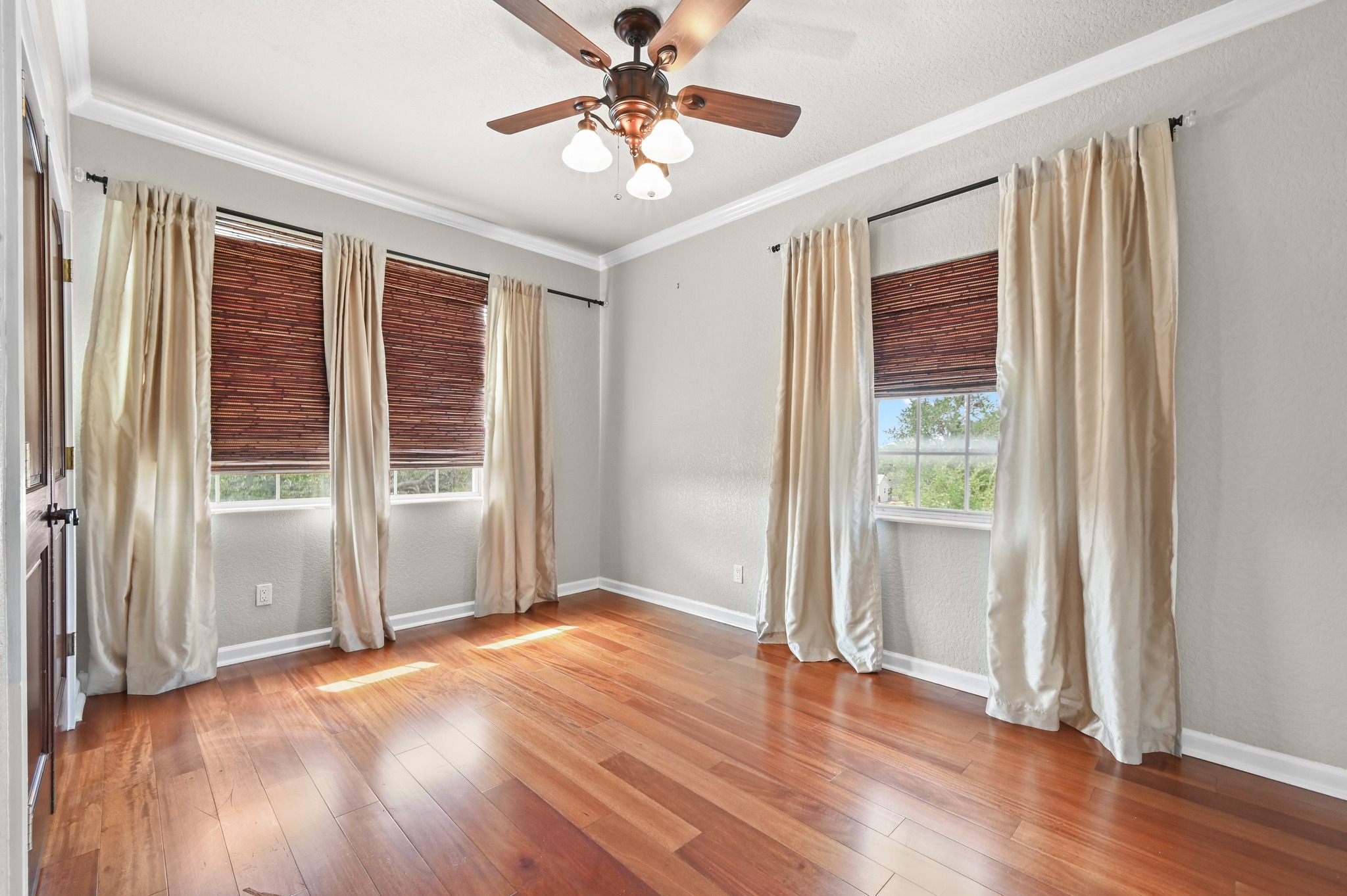 1175 Southern Way Luling, TX 78648 - Photo 30 of 40 Rich hardwood flooring complements natural light pouring into this adaptable living space, ideal for various uses.