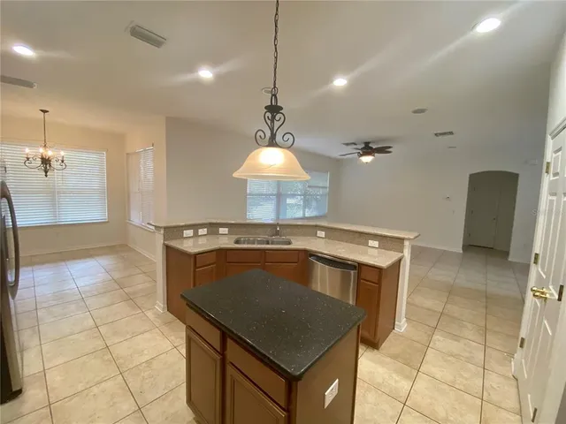 a kitchen with a stove a sink a counter space and cabinets